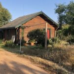 Facing West, driveway and house